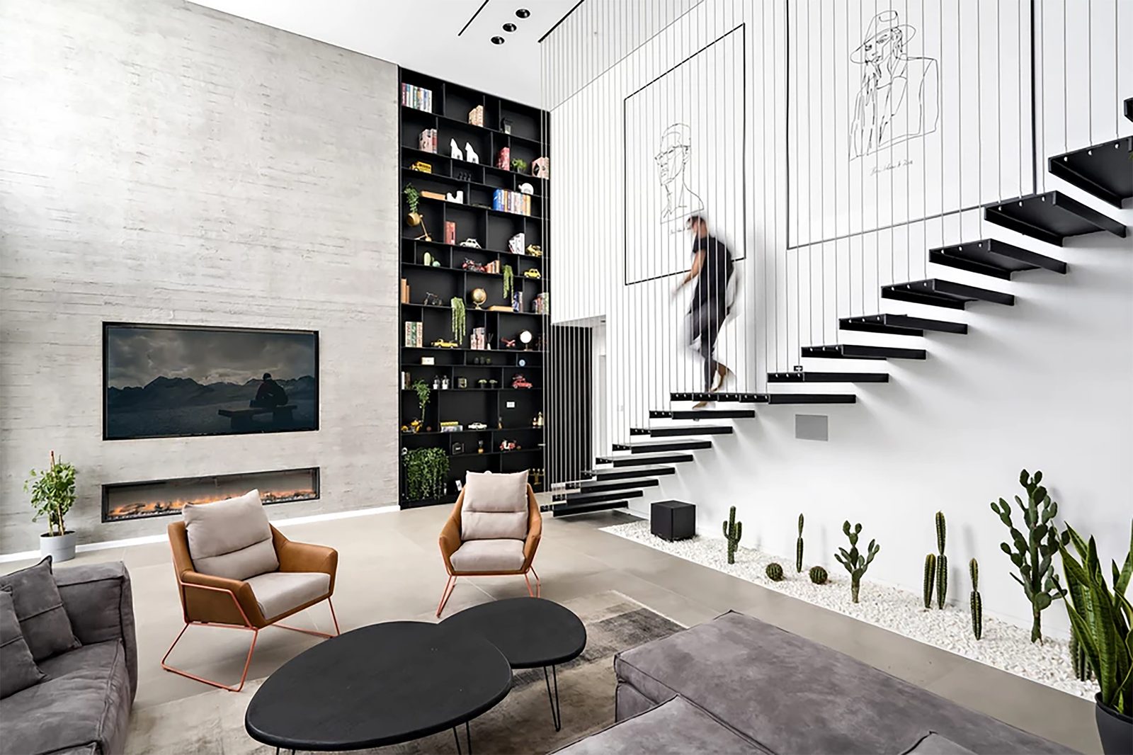 Double-height living room with floating staircase
