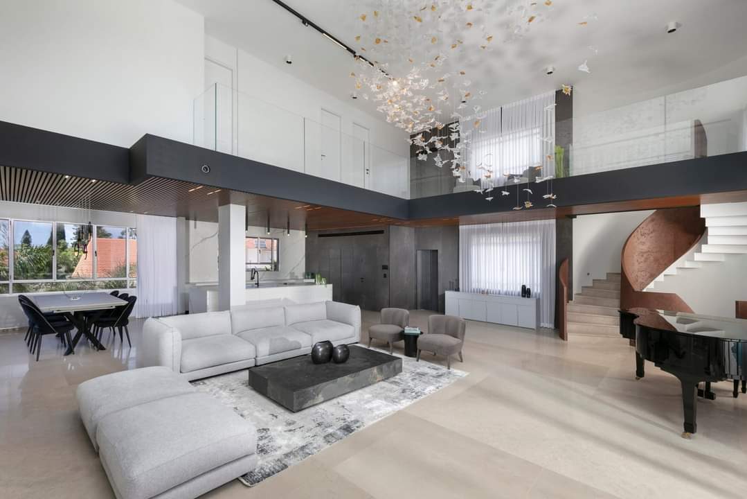 Double-height living room with an open stair in a custom home