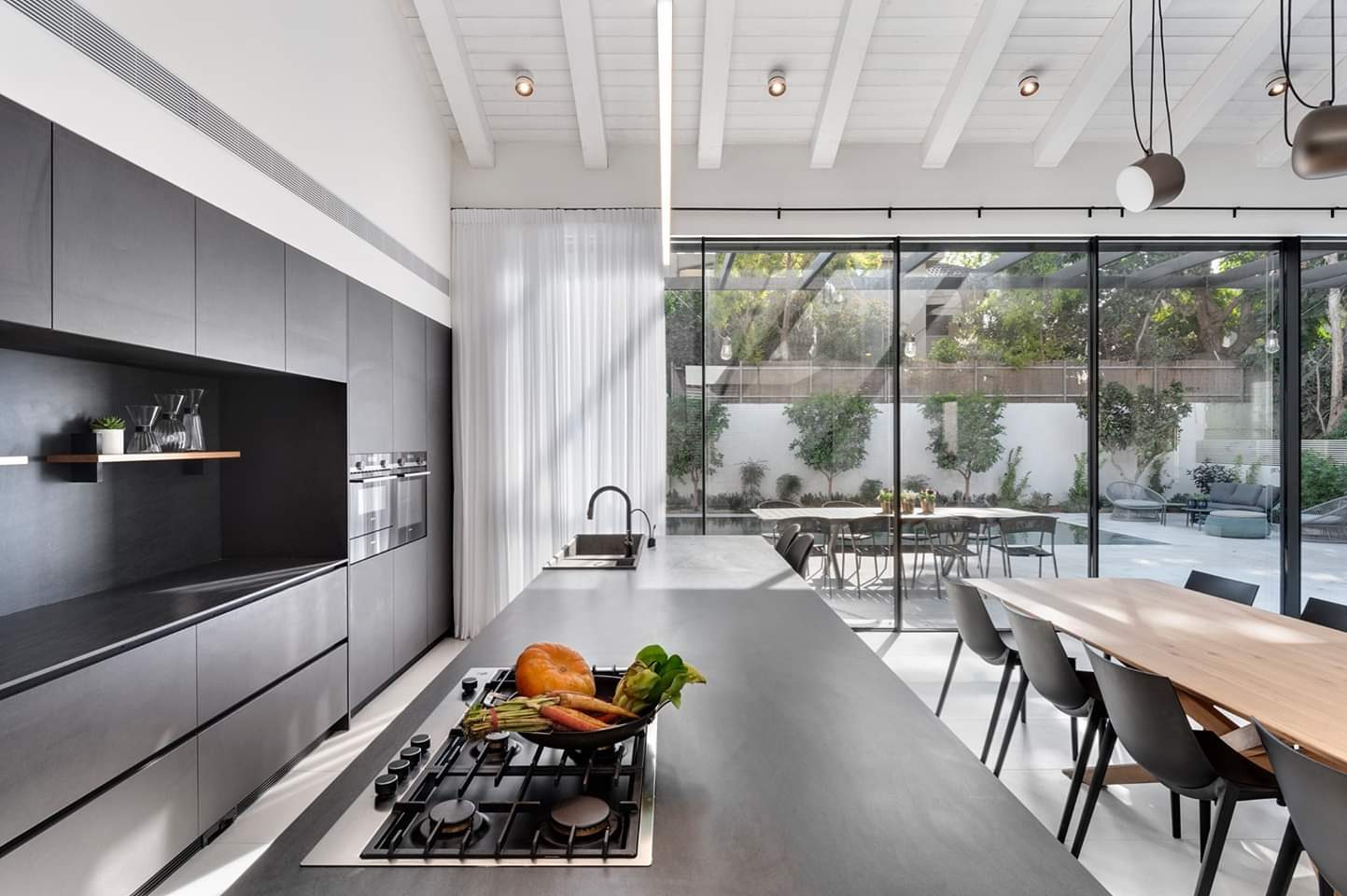 Vaulted open-plan kitchen and dining room in a custom home