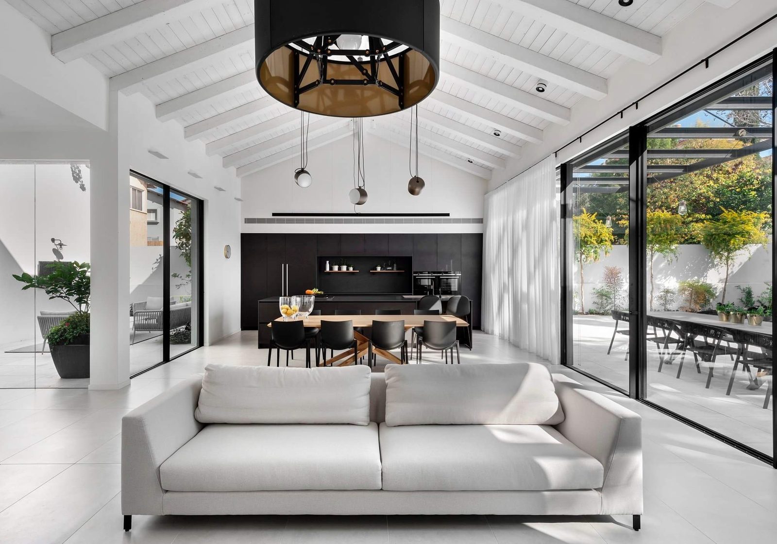 Vaulted living room with full-height glazing in a custom home